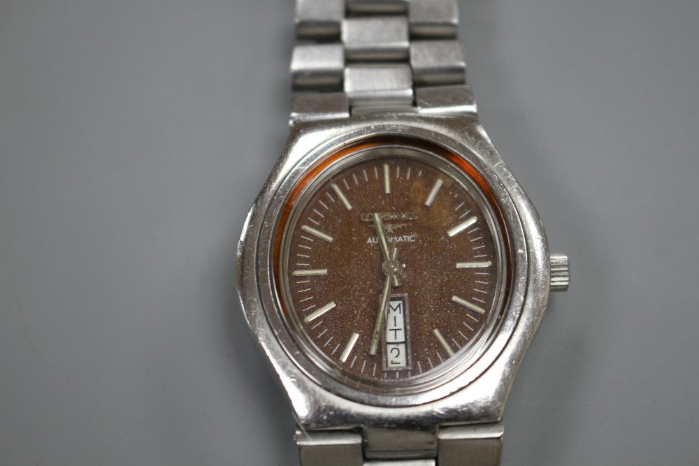 A gentlemans stainless steel Longines automatic wrist watch with coppered oval dial with baton numerals